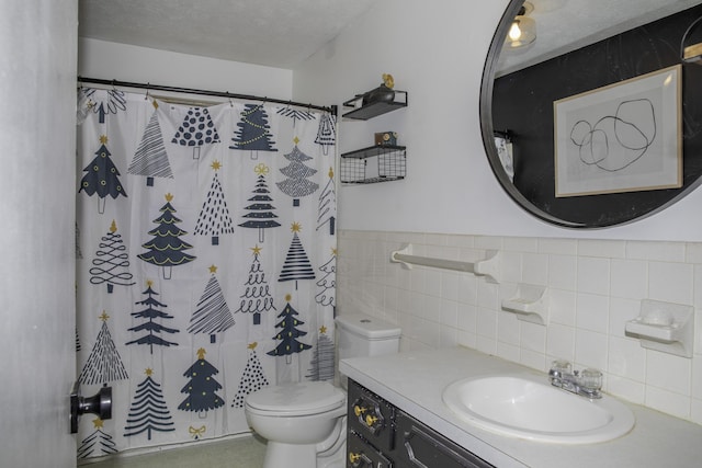 bathroom featuring tile walls, vanity, a textured ceiling, a shower with curtain, and toilet