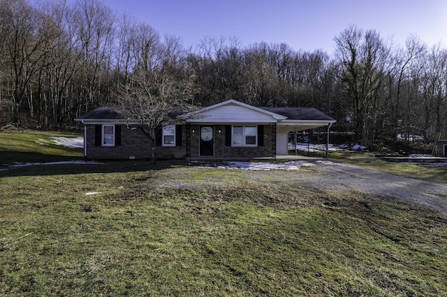 ranch-style house featuring a carport and a front lawn