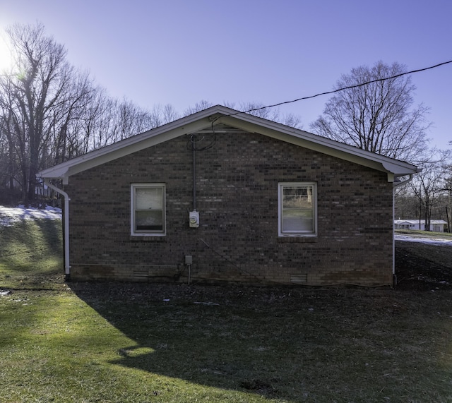 view of side of property with a lawn