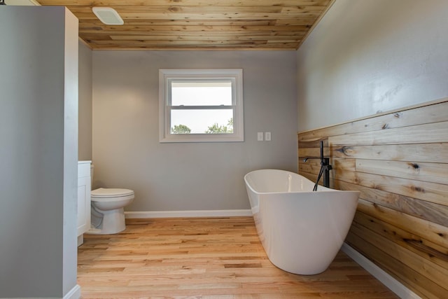 bathroom with wood-type flooring, wood ceiling, a bathtub, and toilet