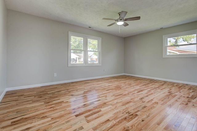 unfurnished room featuring ceiling fan, light hardwood / wood-style flooring, and a textured ceiling