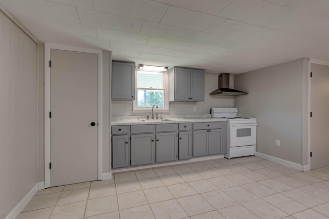 kitchen with wall chimney exhaust hood, sink, light tile patterned floors, electric range, and gray cabinets