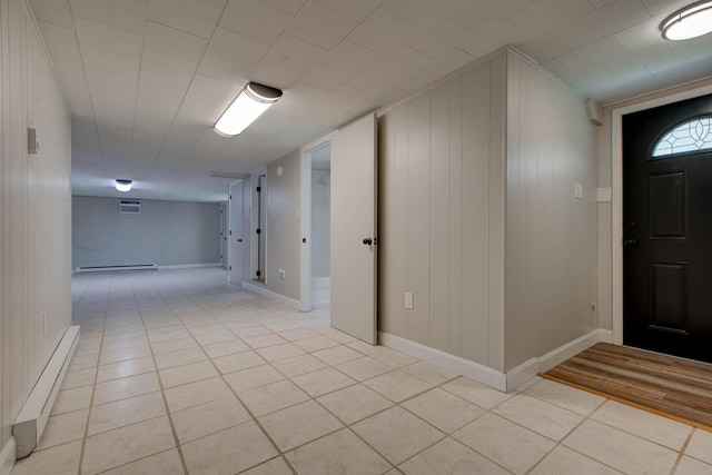 tiled foyer featuring baseboard heating