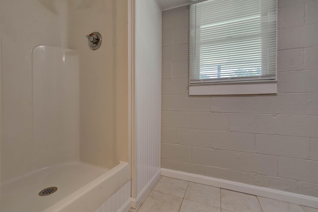 bathroom with a shower and tile patterned floors