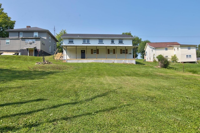 rear view of property with a porch and a yard