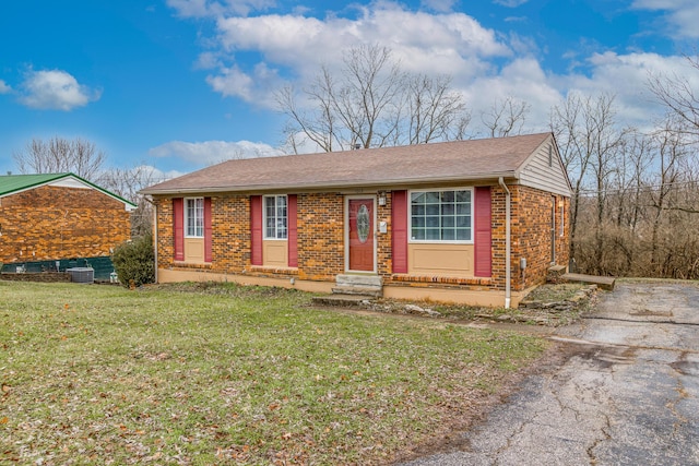 single story home featuring cooling unit and a front lawn