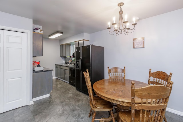 dining area featuring sink and a notable chandelier