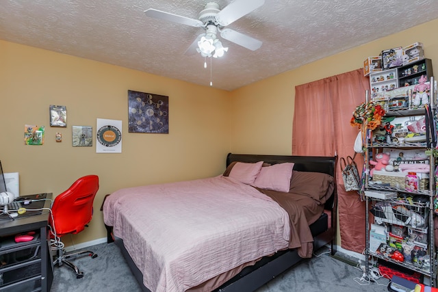 carpeted bedroom featuring ceiling fan and a textured ceiling