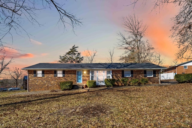 ranch-style house with a yard