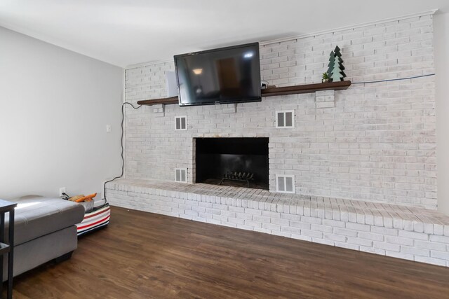 living room featuring a fireplace and dark hardwood / wood-style flooring