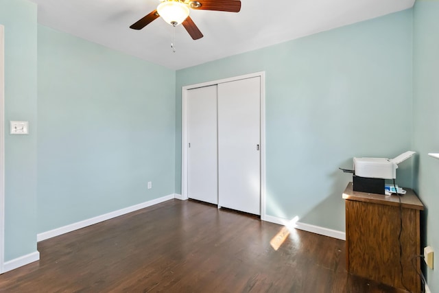 bedroom with ceiling fan, dark hardwood / wood-style flooring, and a closet