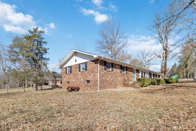 view of home's exterior with a yard