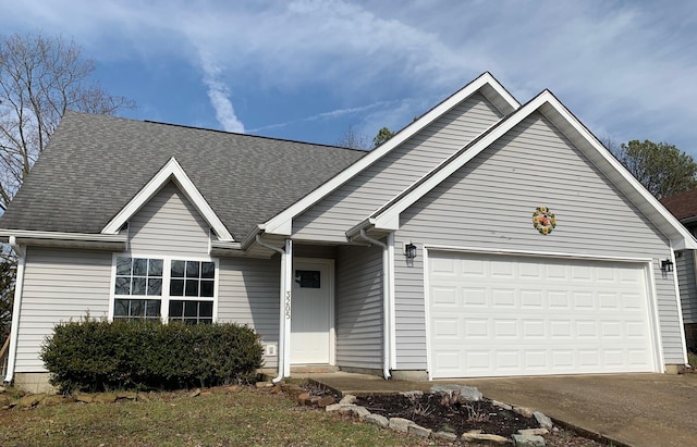 ranch-style house with a garage and a shingled roof