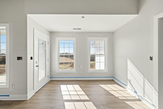 doorway to outside with light wood-type flooring