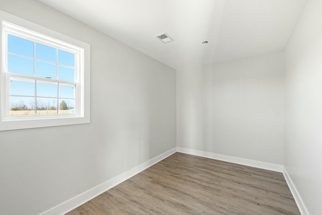 spare room with wood-type flooring