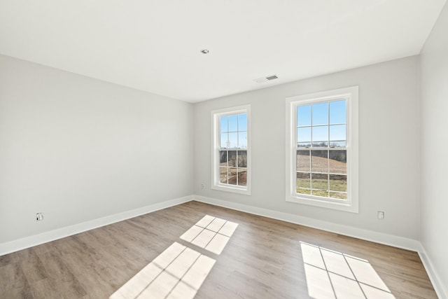 spare room featuring light wood-type flooring