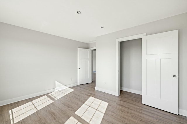 unfurnished bedroom featuring hardwood / wood-style floors