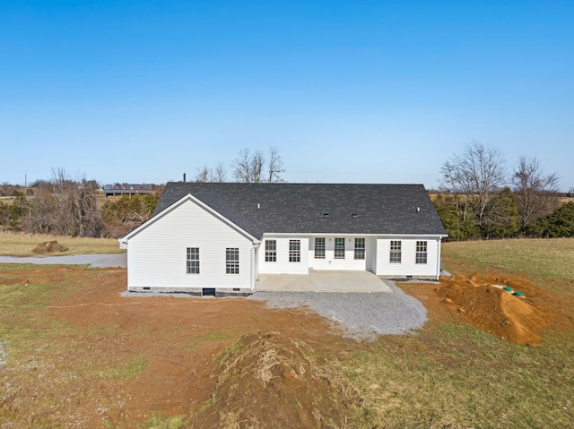 rear view of house with a lawn and a patio area