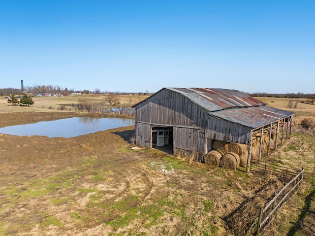 view of outdoor structure featuring a rural view and a water view