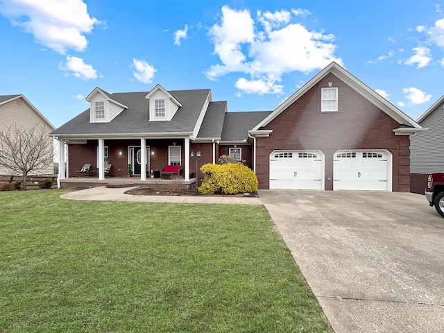 view of front of home with a garage, covered porch, and a front yard