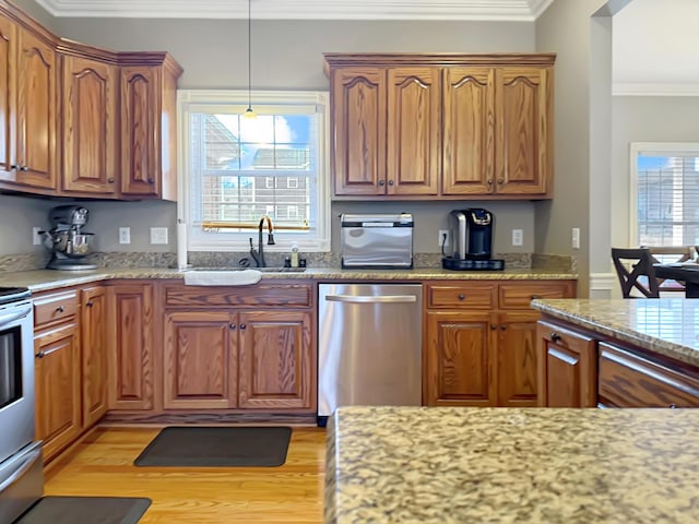 kitchen featuring sink, light stone counters, light wood-type flooring, stainless steel dishwasher, and ornamental molding