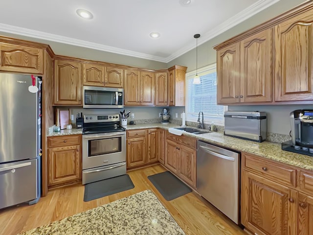 kitchen with sink, ornamental molding, light hardwood / wood-style floors, stainless steel appliances, and light stone countertops