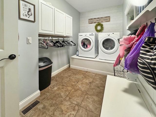 washroom featuring cabinets and washing machine and clothes dryer