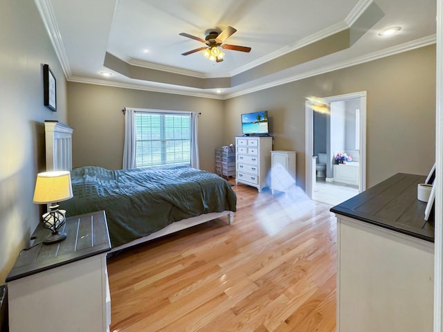 bedroom with a raised ceiling, ornamental molding, ceiling fan, and light wood-type flooring