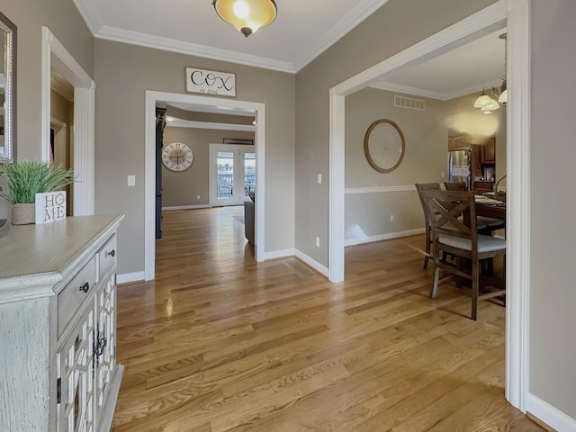 dining room featuring light hardwood / wood-style flooring and ornamental molding