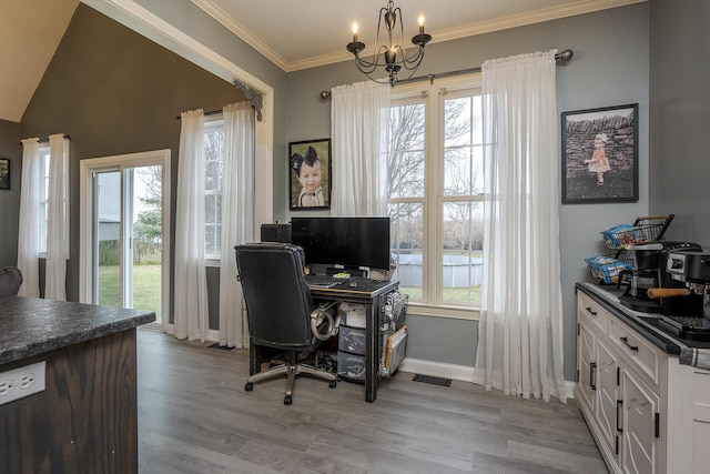 office area featuring ornamental molding, a notable chandelier, and light wood-type flooring