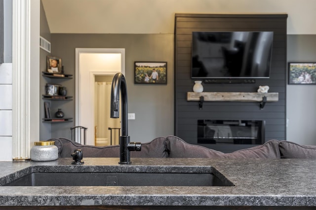 interior space featuring a large fireplace and sink