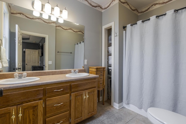 bathroom with vanity, tile patterned floors, and toilet