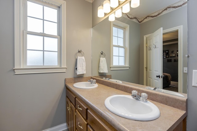 bathroom with vanity, a wealth of natural light, and an inviting chandelier