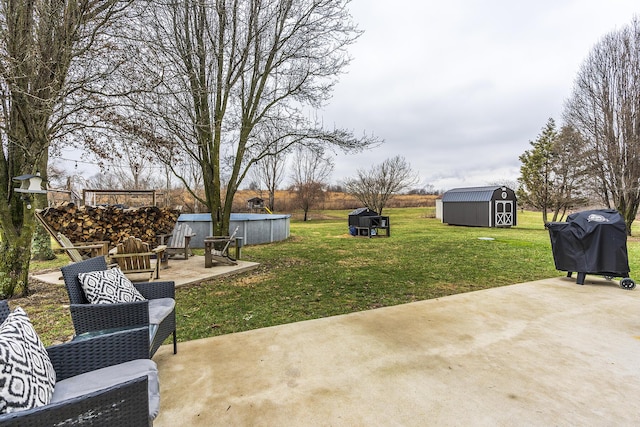 view of yard with a shed and a patio area