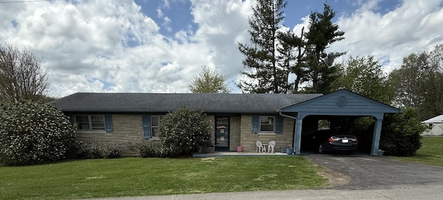 ranch-style home with a front lawn, stone siding, and aphalt driveway