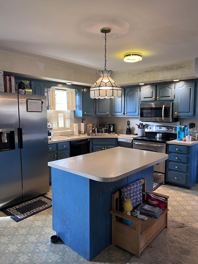 kitchen with blue cabinets, hanging light fixtures, stainless steel appliances, and a kitchen island