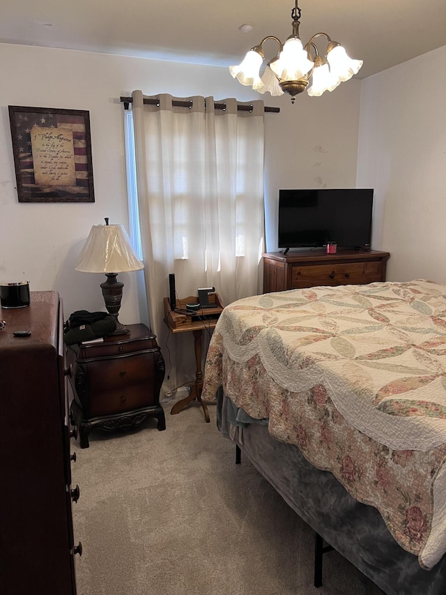 carpeted bedroom with a notable chandelier