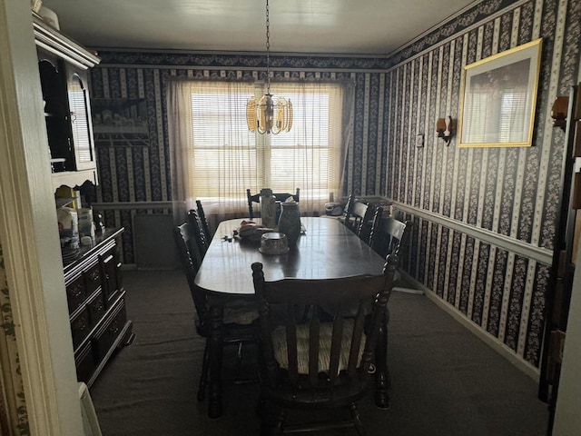 dining space with an inviting chandelier and dark carpet