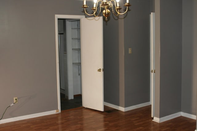 interior space featuring dark hardwood / wood-style flooring and a notable chandelier