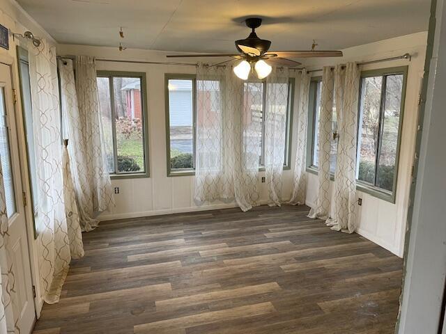 misc room with ceiling fan and dark hardwood / wood-style floors