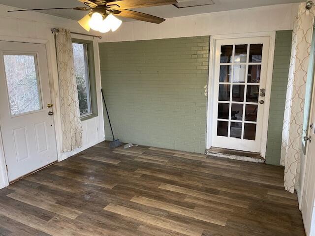 interior space with dark wood-type flooring and ceiling fan