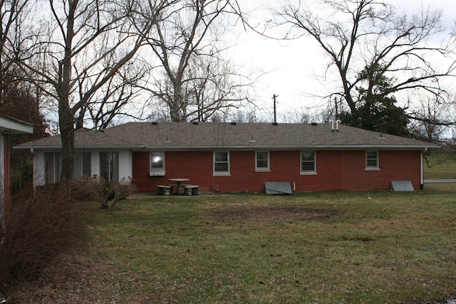 rear view of property featuring a yard