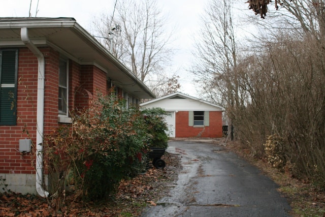 view of property exterior featuring a garage and an outdoor structure