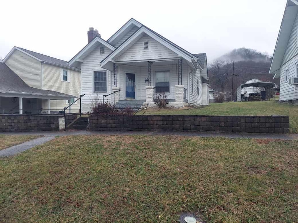 view of front of house with a porch and a front yard