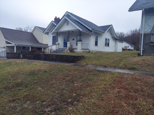 view of front of house featuring covered porch and a front lawn