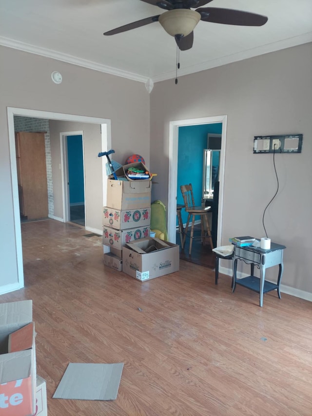 interior space featuring ceiling fan, ornamental molding, and light hardwood / wood-style flooring