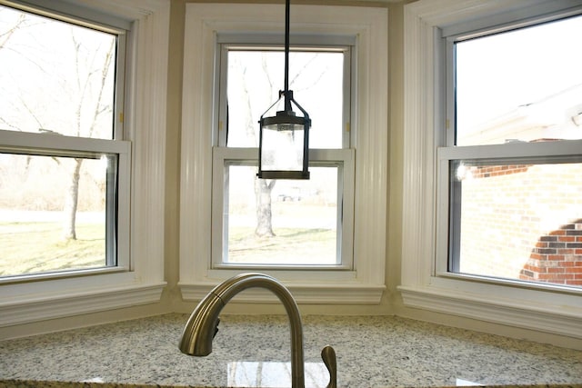 interior details with pendant lighting and light stone counters