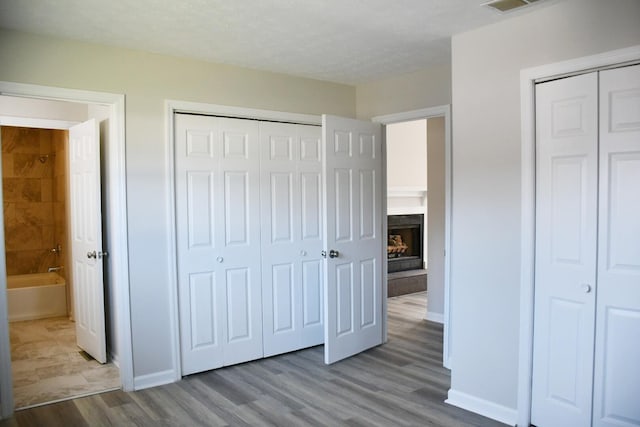 unfurnished bedroom featuring light hardwood / wood-style flooring and a textured ceiling