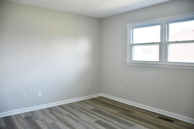 unfurnished room featuring dark wood-type flooring