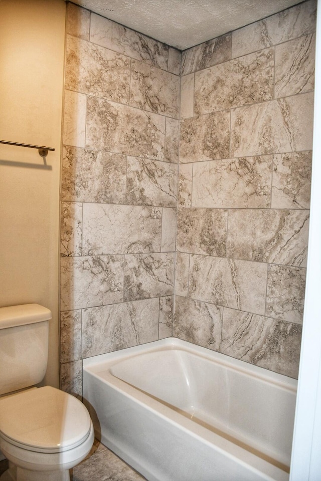 bathroom with toilet and a textured ceiling